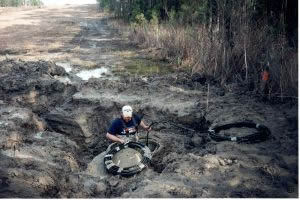 Prepping cable to build a splice location - mud doesn't deter us!