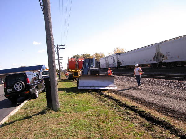 Placing duct with a cable plow along the railroad tracks for a placement & splicing project