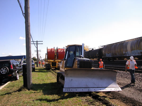 Placing duct with a cable plow along the railroad tracks for a placement & splicing project