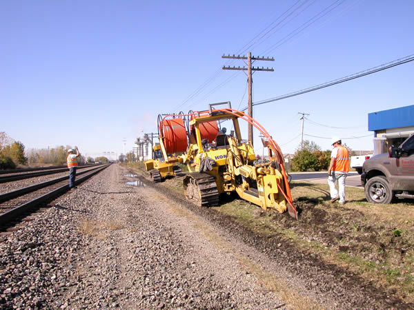 Placing duct with a cable plow along the railroad tracks for a placement & splicing project
